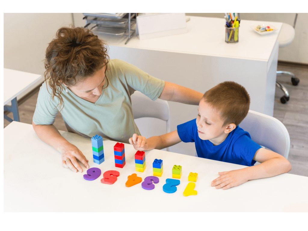 Child learning number recognition and counting with manipulatives for kindergarten readiness.