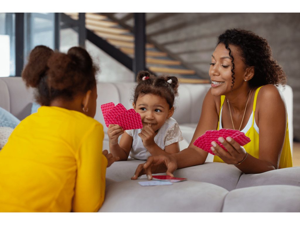 Parent playing card games with children to develop proficiency in following directions.