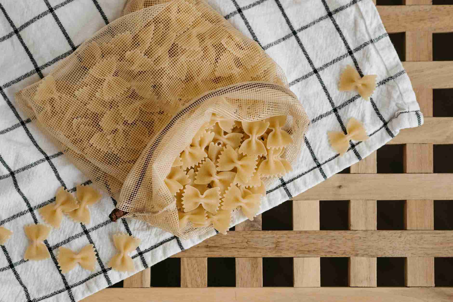 uncooked pasta in a drawstring mesh bag